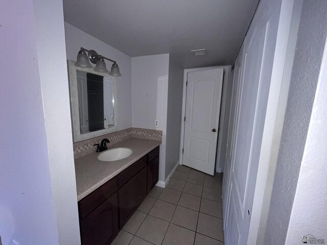 bathroom featuring decorative backsplash, vanity, and tile patterned floors