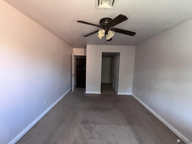 unfurnished bedroom with dark colored carpet and ceiling fan