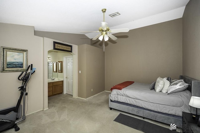 bedroom with arched walkways, lofted ceiling, light carpet, visible vents, and baseboards