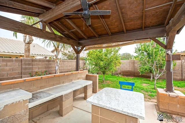 view of patio with a fenced backyard, ceiling fan, and a gazebo