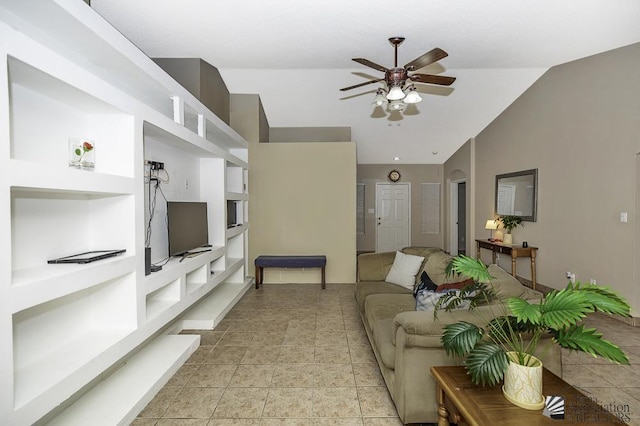 living room featuring lofted ceiling, light tile patterned floors, and a ceiling fan