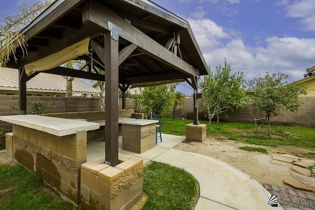 view of patio featuring a gazebo and a fenced backyard