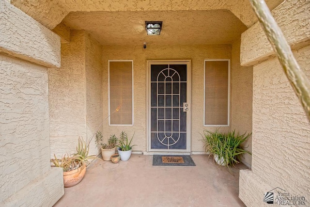 property entrance with stucco siding