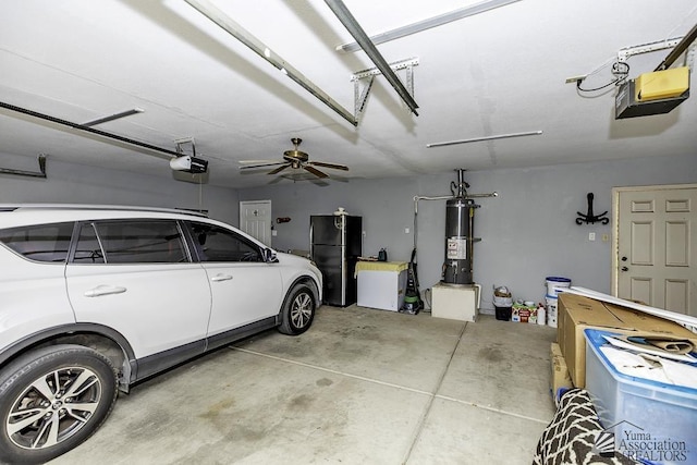 garage featuring a garage door opener, freestanding refrigerator, and water heater