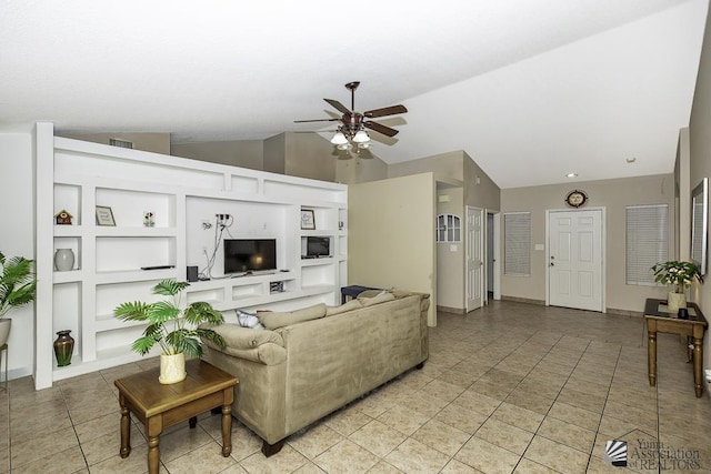 living area with built in shelves, light tile patterned floors, lofted ceiling, a ceiling fan, and baseboards