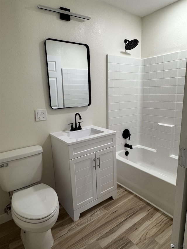 full bathroom with toilet, wood-type flooring, shower / washtub combination, and vanity