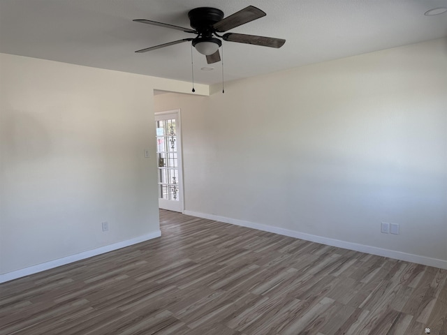 spare room featuring ceiling fan and dark hardwood / wood-style floors