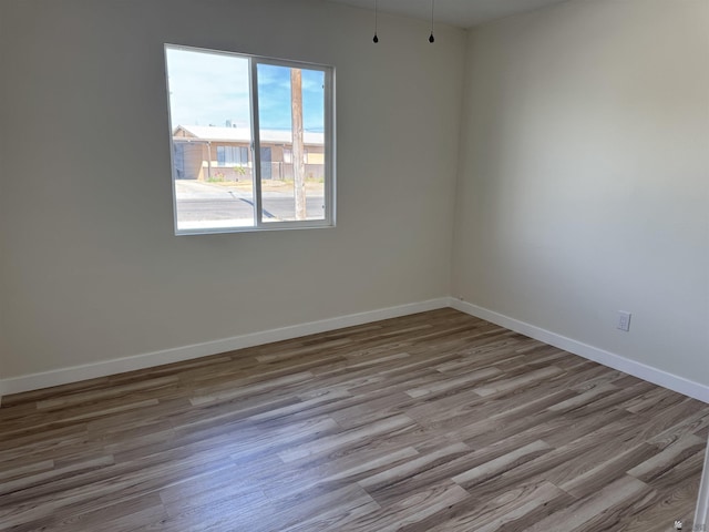 empty room with light hardwood / wood-style flooring