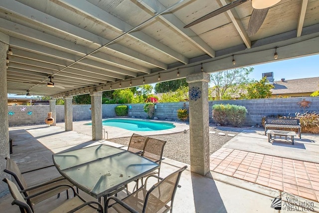 view of patio with a fenced backyard, a ceiling fan, a fenced in pool, and outdoor dining space