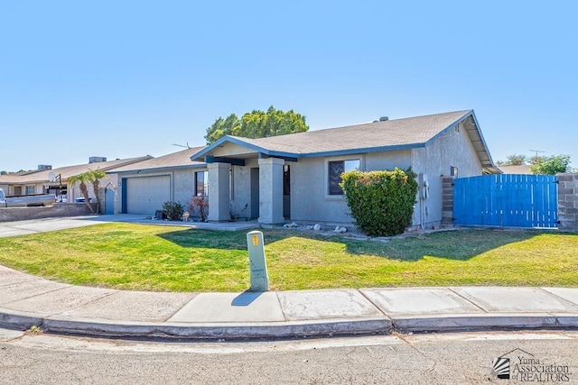 view of front of house with concrete driveway, stucco siding, an attached garage, fence, and a front yard