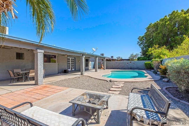 view of swimming pool with a fenced in pool, an outdoor fire pit, a fenced backyard, and a patio