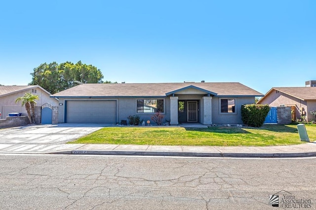 ranch-style home with a front lawn, driveway, an attached garage, and stucco siding