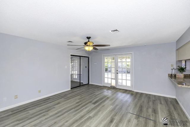 unfurnished room featuring french doors, baseboards, visible vents, and light wood finished floors