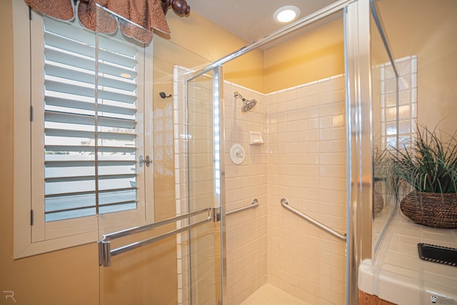 bathroom with a shower with shower door