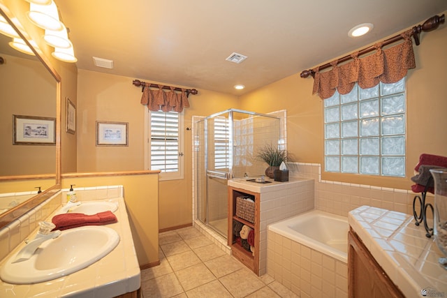 bathroom with independent shower and bath, vanity, and tile patterned floors