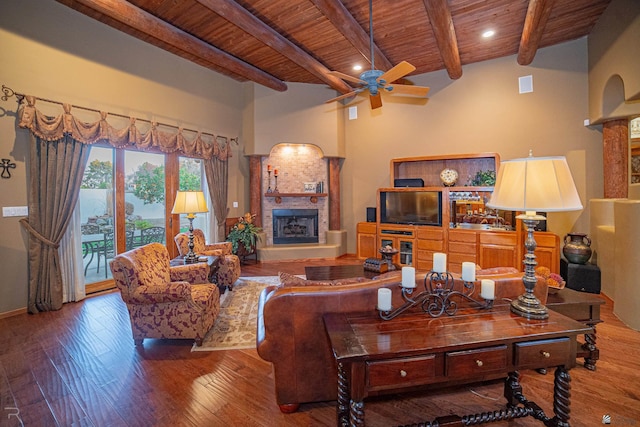 living room with hardwood / wood-style floors, wood ceiling, beamed ceiling, and ceiling fan