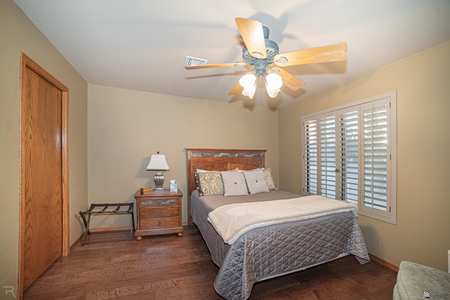 bedroom with dark wood-type flooring and ceiling fan