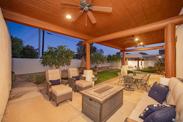 patio terrace at dusk with outdoor lounge area and ceiling fan