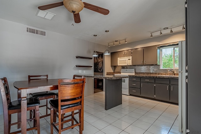 kitchen with white appliances, backsplash, sink, ceiling fan, and decorative light fixtures