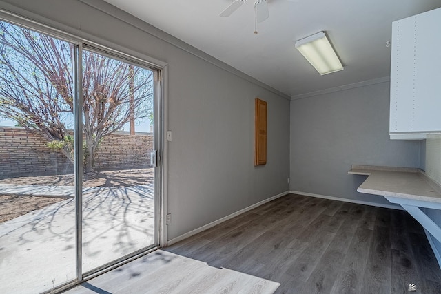 interior space featuring hardwood / wood-style floors, ceiling fan, and ornamental molding