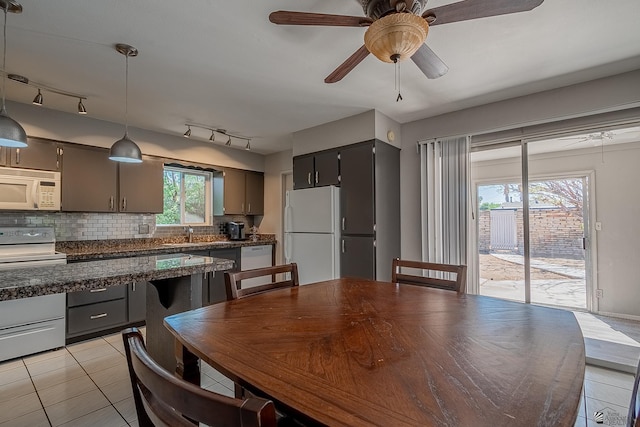 kitchen featuring backsplash, white appliances, ceiling fan, sink, and pendant lighting