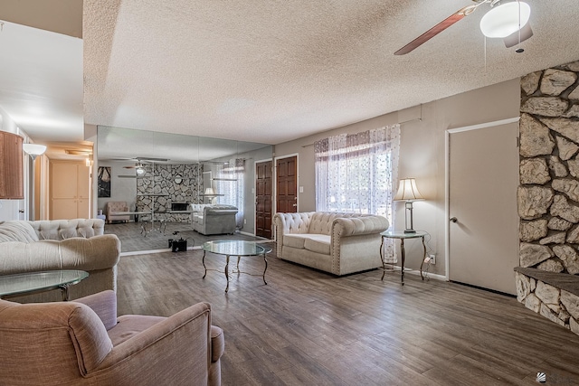 living room with wood-type flooring and a textured ceiling