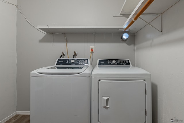 laundry area featuring wood-type flooring and separate washer and dryer