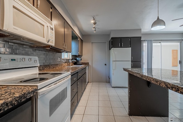 kitchen with backsplash, rail lighting, white appliances, sink, and light tile patterned floors