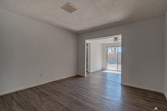 spare room featuring a textured ceiling, ceiling fan, and dark wood-type flooring