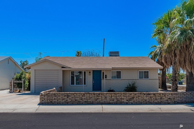 single story home with a garage and central air condition unit