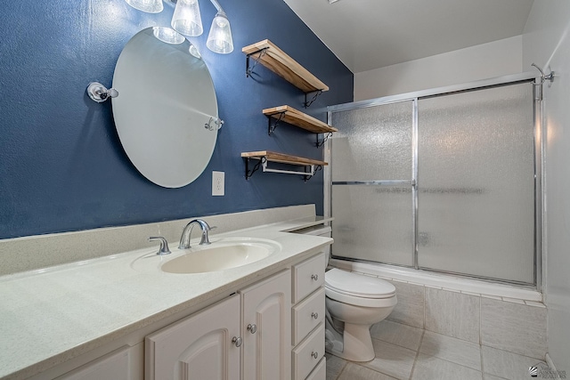 full bathroom with tile patterned flooring, vanity, toilet, and bath / shower combo with glass door