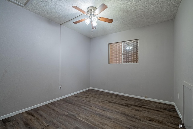 spare room featuring ceiling fan, dark hardwood / wood-style flooring, and a textured ceiling