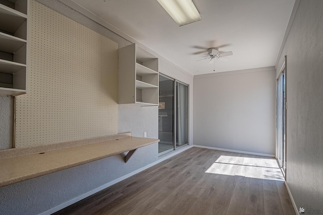 interior space featuring hardwood / wood-style floors, ceiling fan, and crown molding