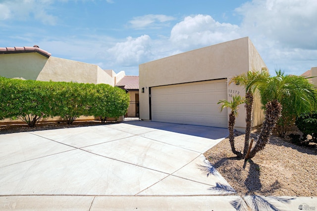 pueblo-style home featuring a garage