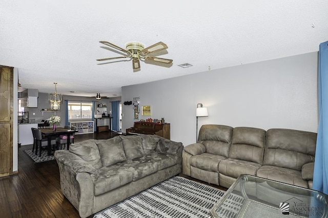 living room featuring ceiling fan, dark wood-type flooring, a textured ceiling, and visible vents