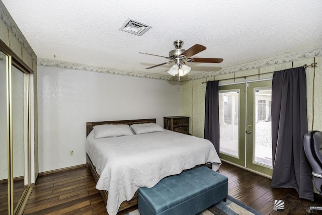 bedroom featuring access to exterior, french doors, wood-type flooring, visible vents, and a textured ceiling