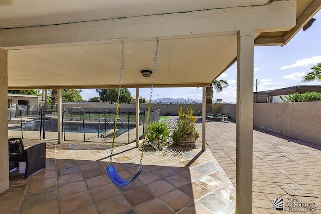 view of patio featuring a fenced in pool and fence