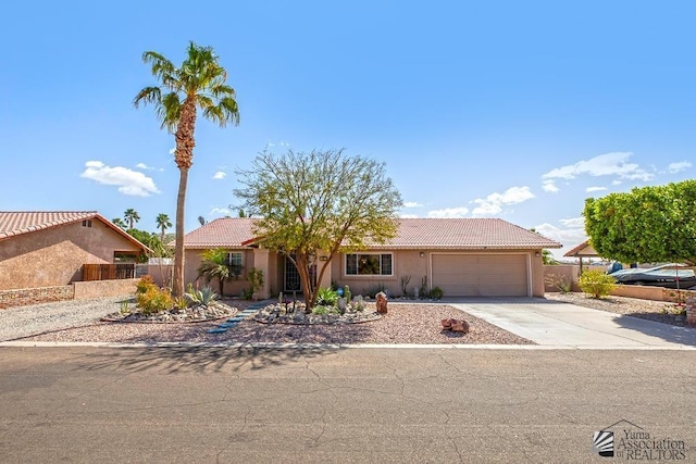 ranch-style house with concrete driveway, fence, a tiled roof, and stucco siding