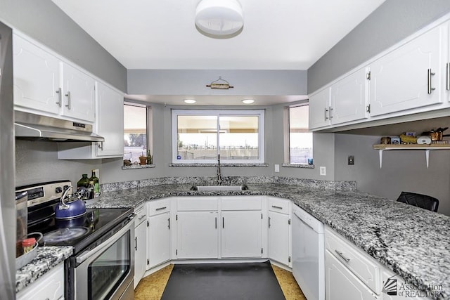 kitchen featuring stainless steel electric range oven, white cabinets, white dishwasher, a sink, and under cabinet range hood