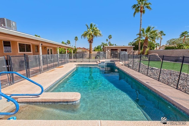 view of pool with a fenced in pool, an outbuilding, fence, and a patio