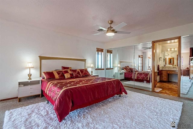 bedroom with ceiling fan, carpet floors, a textured ceiling, and a closet