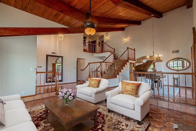 living room with beamed ceiling, a towering ceiling, ceiling fan with notable chandelier, and wooden ceiling