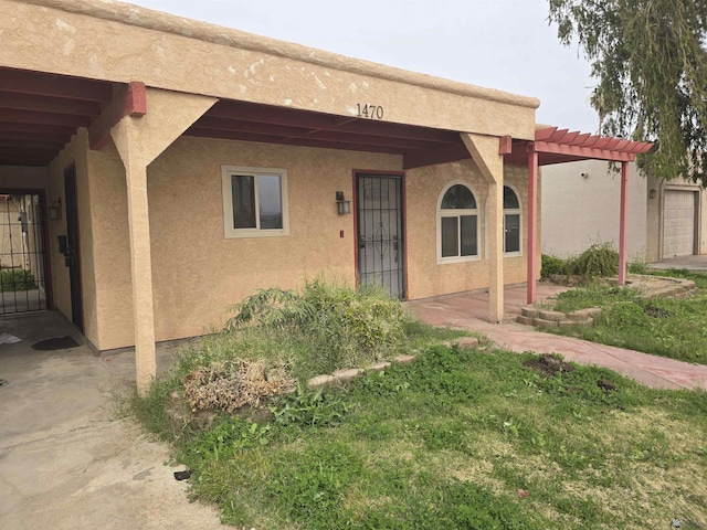 property entrance with a pergola