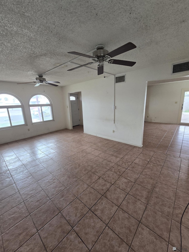 spare room featuring ceiling fan and a textured ceiling