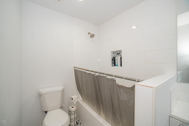 bathroom with toilet and shower / tub combo with curtain