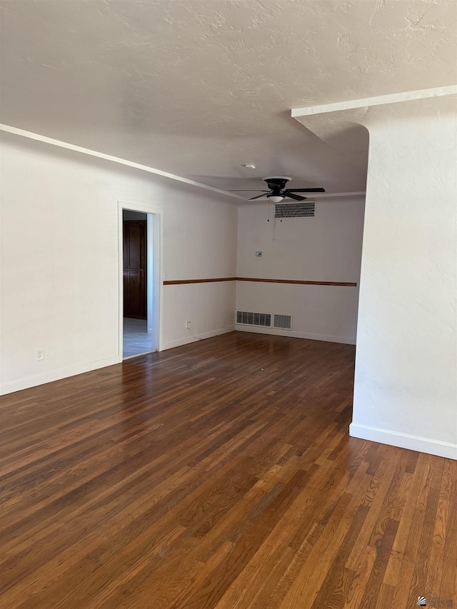 spare room featuring baseboards, a textured ceiling, wood finished floors, and a ceiling fan