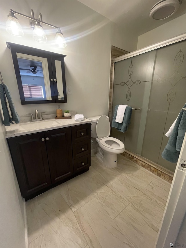 full bath with toilet, a stall shower, vanity, and marble finish floor