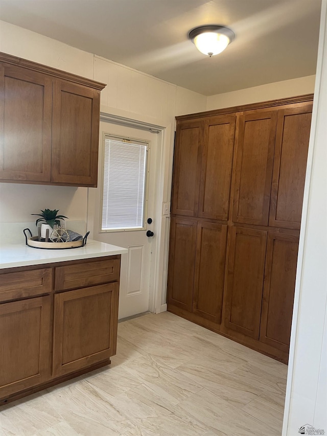 kitchen with brown cabinetry and light countertops