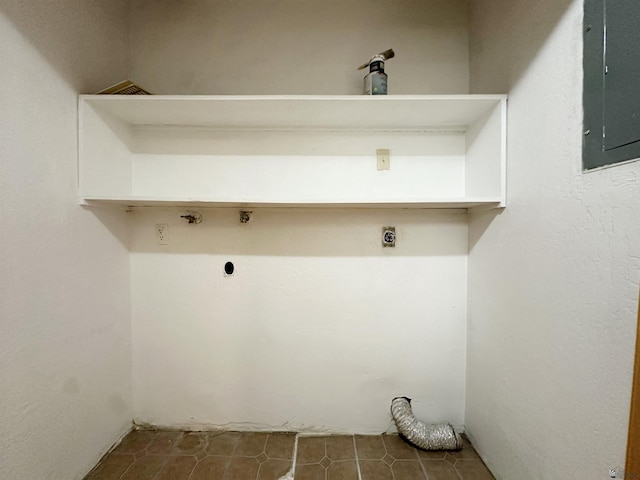 washroom featuring electric dryer hookup, dark tile patterned floors, and electric panel