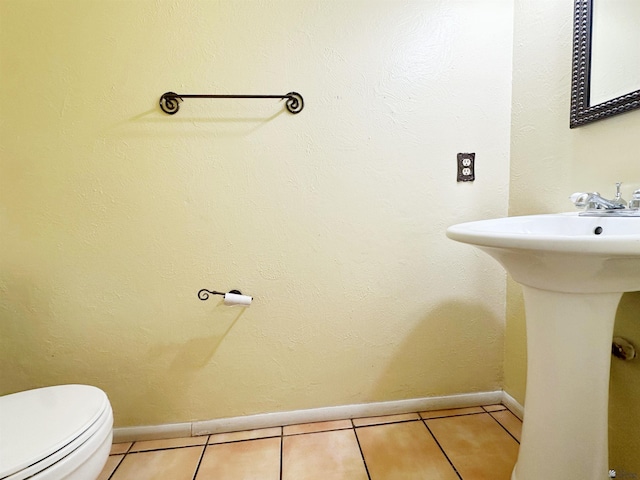 bathroom featuring tile patterned flooring and toilet